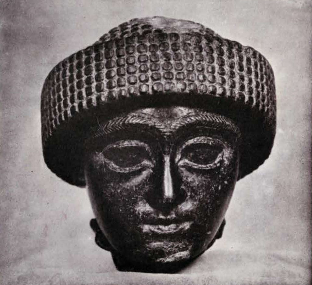 Head with thick eyebrows and turban, front view