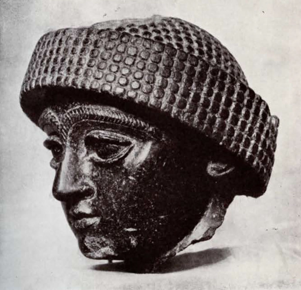 Head with thick eyebrows and turban, side view