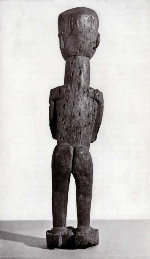 Simple fetish of standing male figure, covered in nail holes, back view