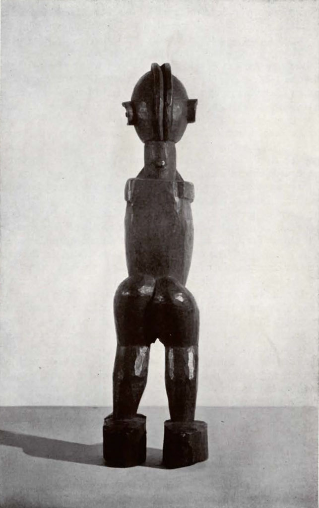 Wooden statuette of a standing figure with hands together under their chin, back view