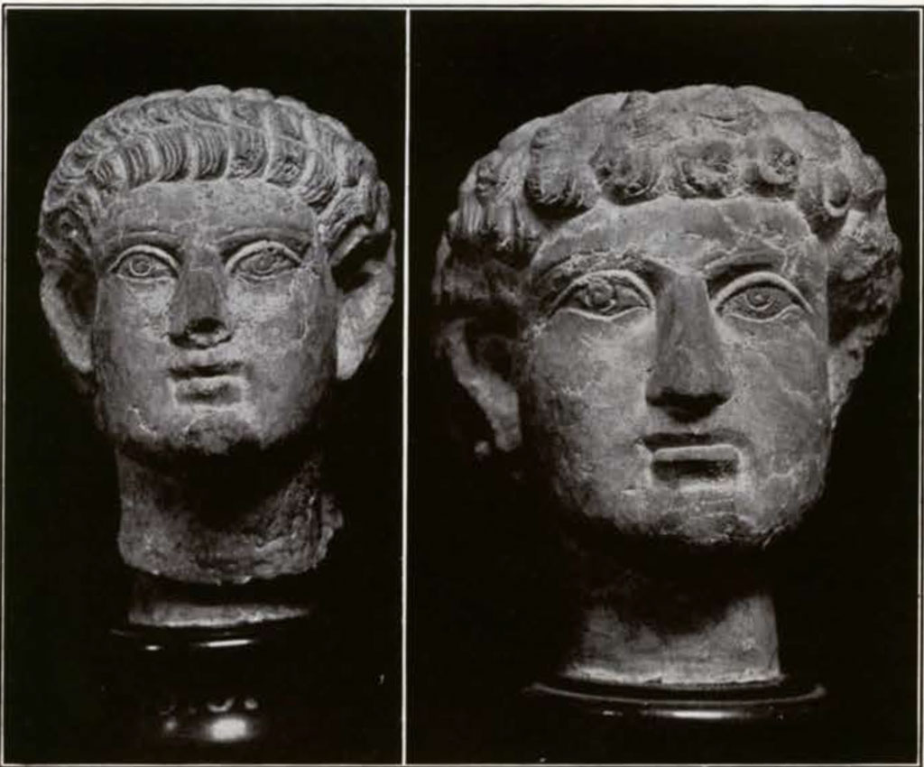 Two busts of men with curly hair